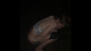 Girlfriend peeing along road at night