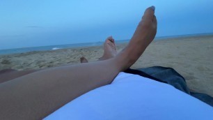 Foot job on public beach