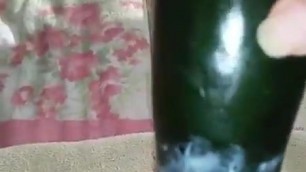 Girl fucking herself with a cucumber