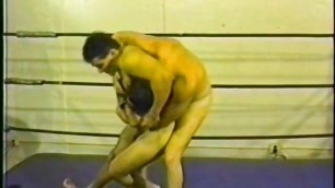 Two fit wrestlers fight naked in a boxing rink